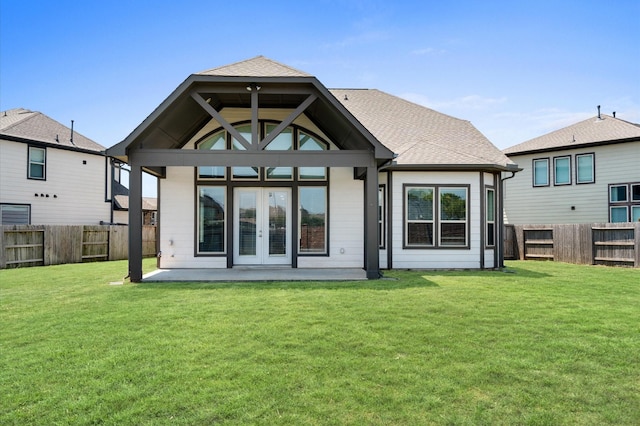 rear view of property with french doors and a lawn