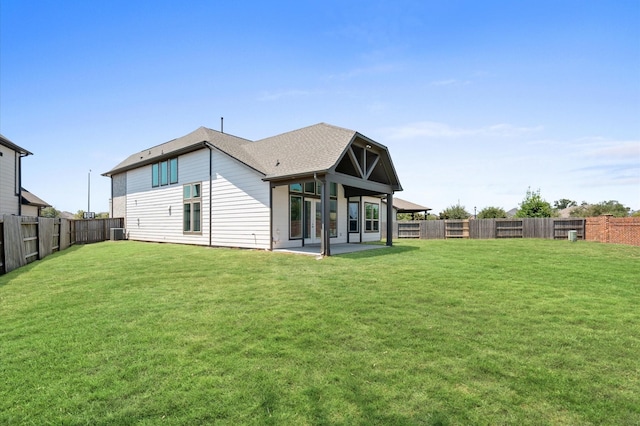 back of house with a yard and a patio