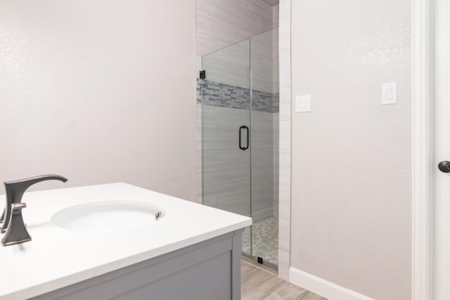 bathroom with vanity, wood-type flooring, and walk in shower