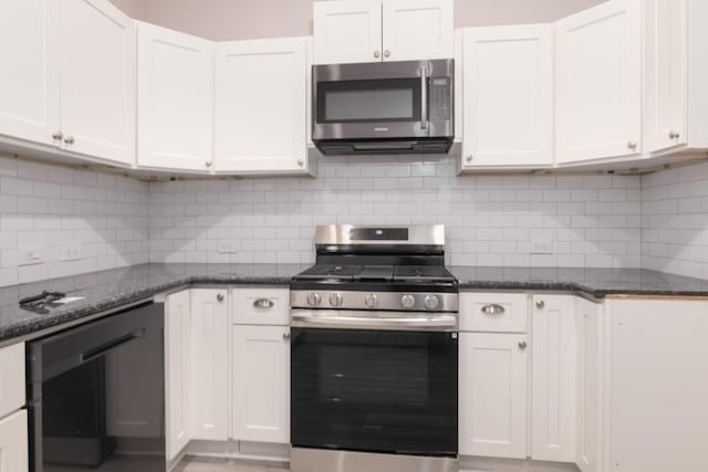 kitchen featuring decorative backsplash, stainless steel appliances, and white cabinetry