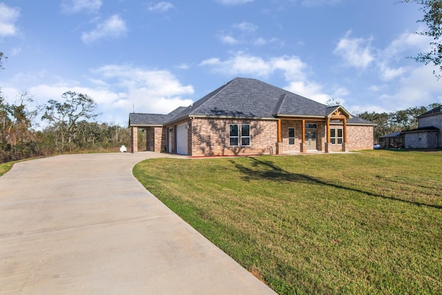 view of front of property with a front yard and a garage