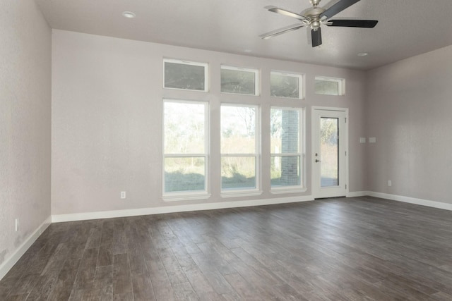 unfurnished room with ceiling fan and dark wood-type flooring