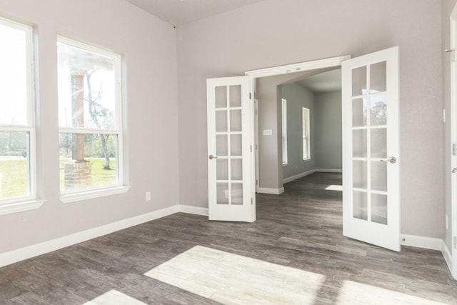 spare room with french doors and dark wood-type flooring