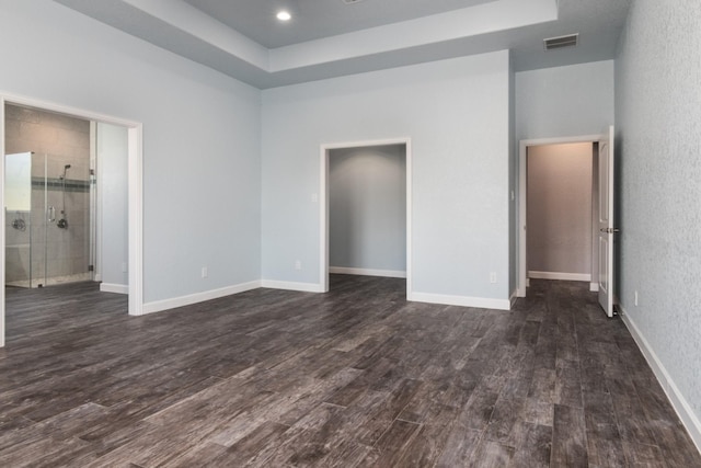 unfurnished bedroom with dark hardwood / wood-style floors and ensuite bath