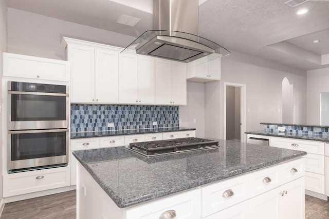 kitchen with white cabinetry, island range hood, dark hardwood / wood-style flooring, and stainless steel appliances