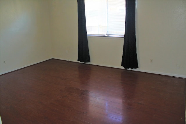 spare room featuring dark wood-type flooring