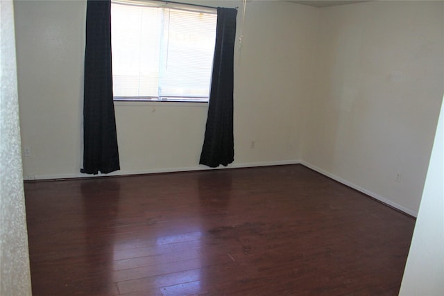 unfurnished room featuring dark hardwood / wood-style floors