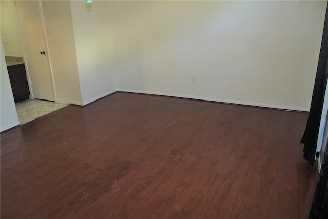 unfurnished room featuring dark wood-type flooring