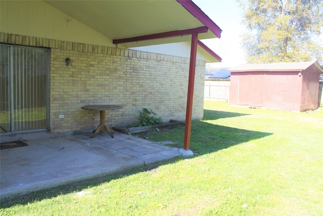 view of yard featuring a storage unit and a patio area