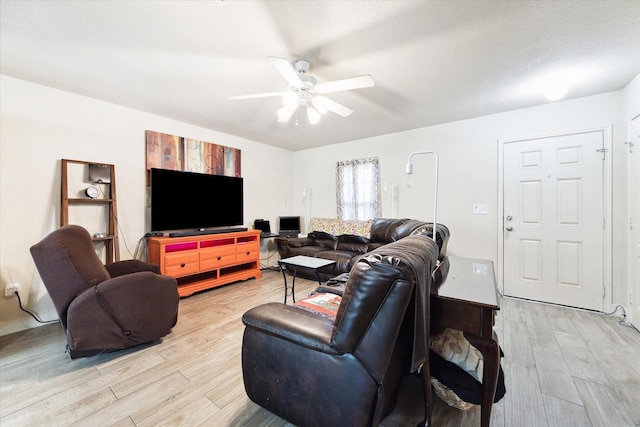 living room featuring light hardwood / wood-style floors and ceiling fan