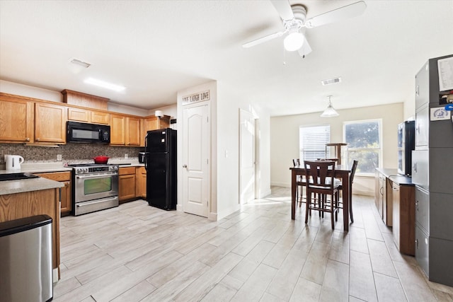 kitchen featuring pendant lighting, backsplash, black appliances, ceiling fan, and light wood-type flooring