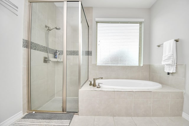 bathroom with shower with separate bathtub and tile patterned floors