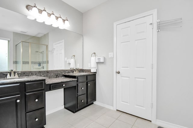 bathroom featuring tile patterned floors, vanity, and a shower with shower door