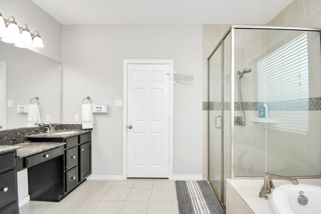 bathroom with tile patterned floors, vanity, and shower with separate bathtub