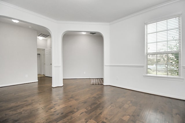 empty room with ornamental molding, dark hardwood / wood-style floors, and a healthy amount of sunlight