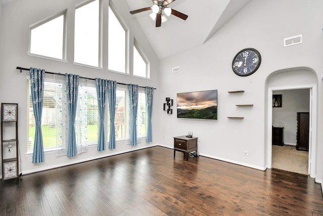 unfurnished living room with ceiling fan, high vaulted ceiling, and dark hardwood / wood-style floors