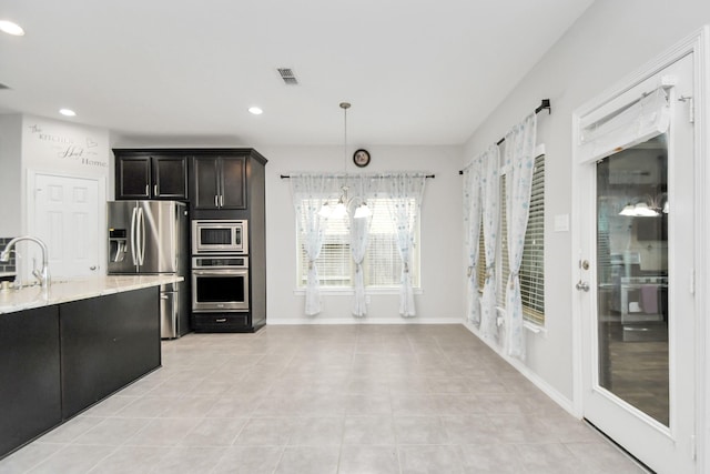 kitchen with sink, decorative light fixtures, light tile patterned floors, a notable chandelier, and stainless steel appliances