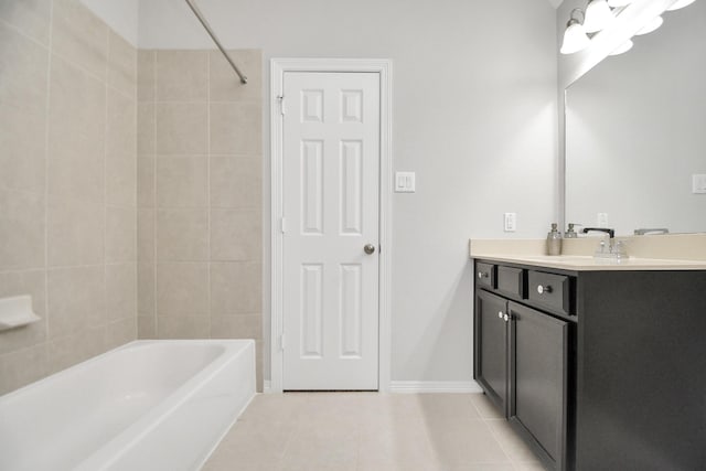 bathroom featuring tile patterned floors, vanity, and tiled shower / bath