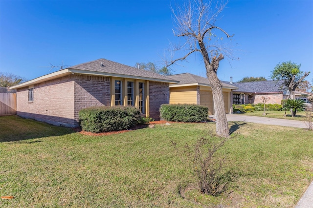 single story home featuring a front yard and a garage