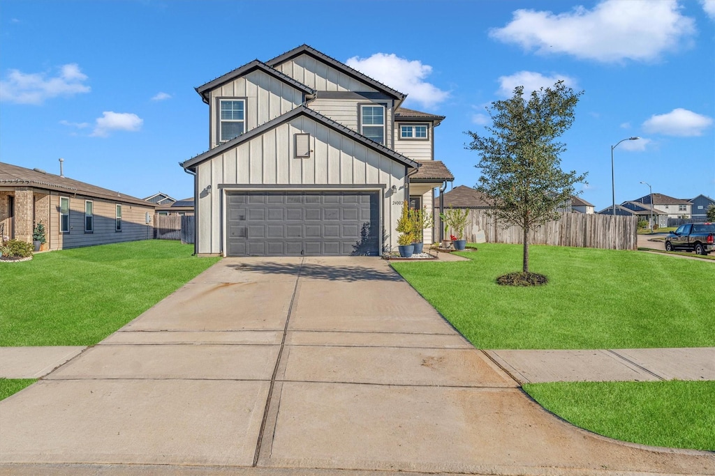 view of front of property with a front yard and a garage