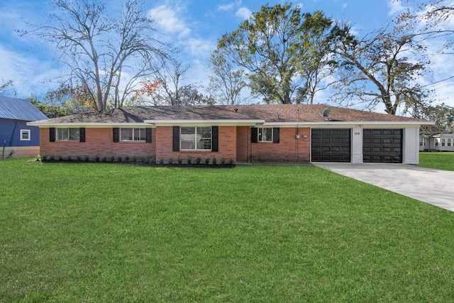 ranch-style house featuring a front yard and a garage