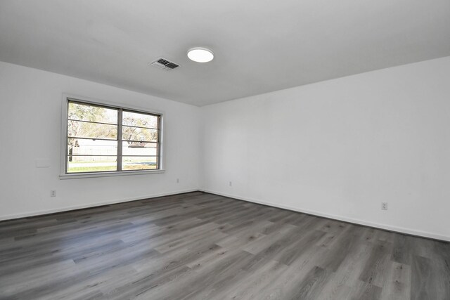 unfurnished room with dark hardwood / wood-style floors