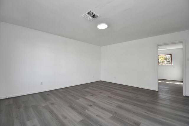 unfurnished room with dark hardwood / wood-style floors