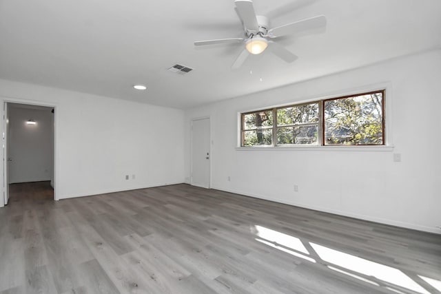 spare room featuring hardwood / wood-style flooring and ceiling fan