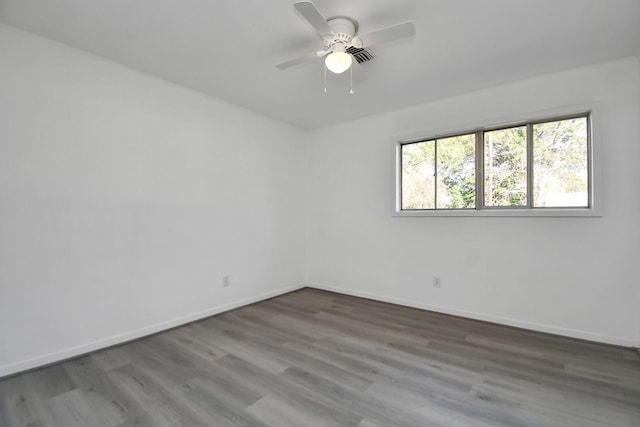 empty room featuring hardwood / wood-style flooring and ceiling fan