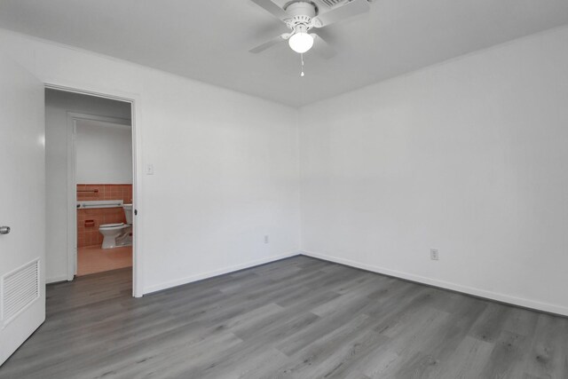 empty room featuring dark hardwood / wood-style floors and ceiling fan