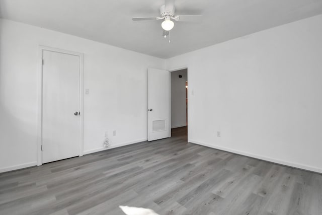 spare room featuring ceiling fan and light hardwood / wood-style floors