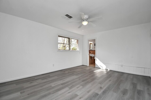 empty room featuring hardwood / wood-style flooring and ceiling fan