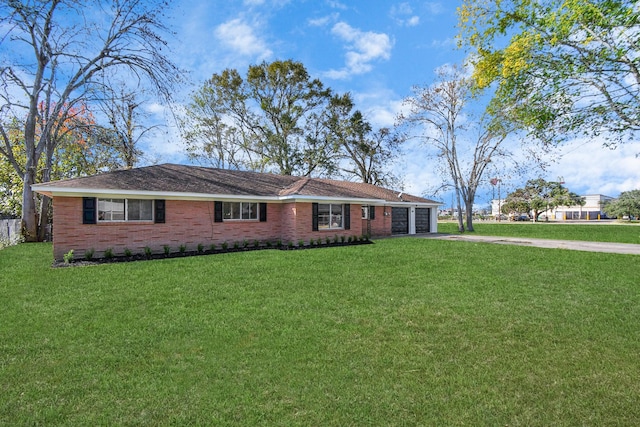 single story home featuring a front lawn and a garage