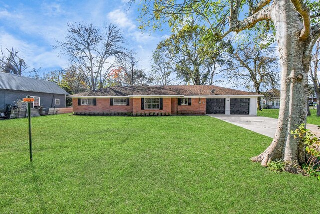 ranch-style home with a front yard and a garage