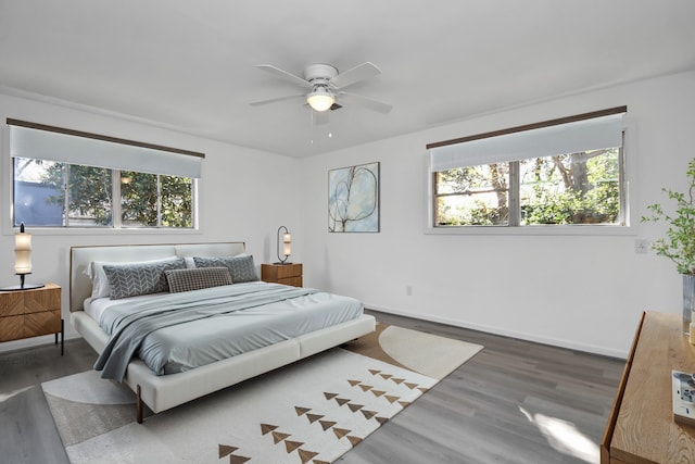 bedroom featuring ceiling fan and dark wood-type flooring