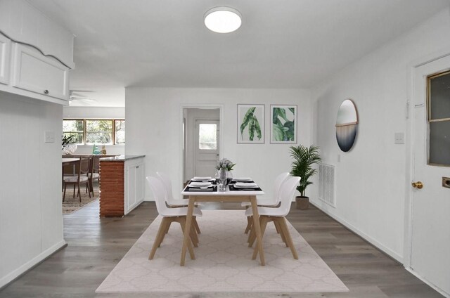 dining area featuring ceiling fan and dark hardwood / wood-style flooring