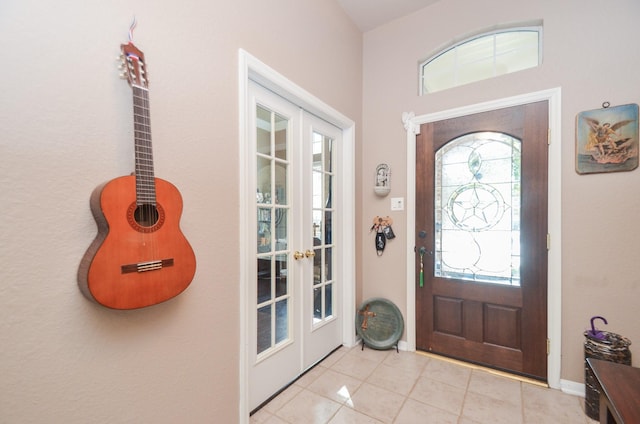 tiled foyer featuring french doors