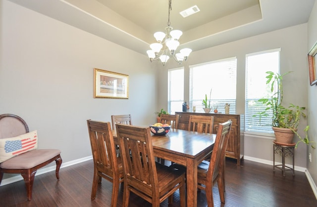 dining space featuring a wealth of natural light, dark hardwood / wood-style flooring, and a notable chandelier