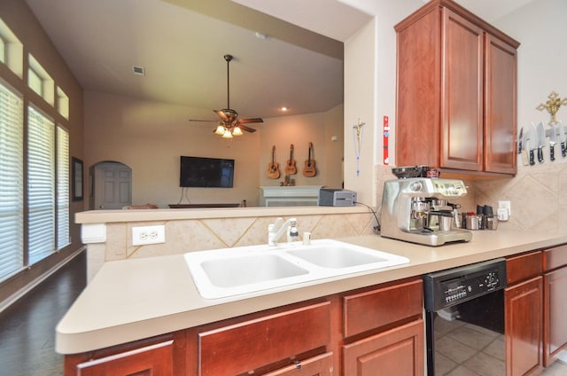 kitchen featuring sink, dark wood-type flooring, black dishwasher, tasteful backsplash, and kitchen peninsula