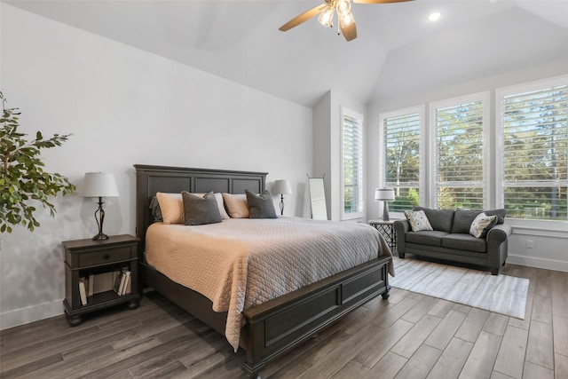 bedroom featuring ceiling fan, dark wood-type flooring, and lofted ceiling