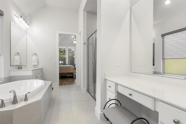 bathroom with ceiling fan, separate shower and tub, lofted ceiling, and vanity