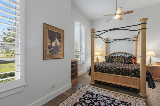 bedroom with dark hardwood / wood-style flooring and ceiling fan