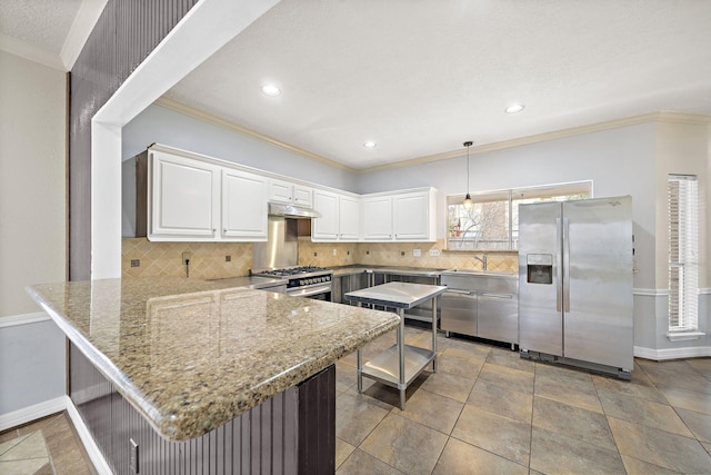 kitchen featuring kitchen peninsula, decorative backsplash, stainless steel appliances, decorative light fixtures, and white cabinetry