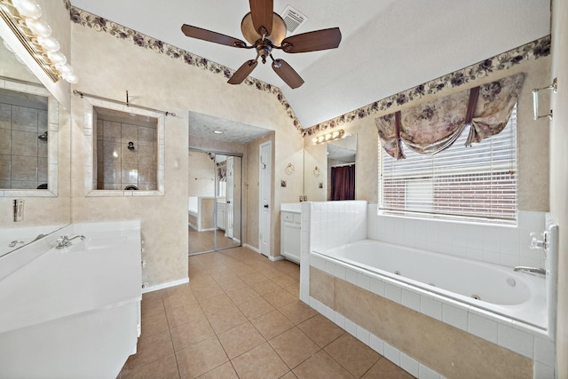 bathroom featuring vanity, lofted ceiling, plus walk in shower, tile patterned floors, and ceiling fan