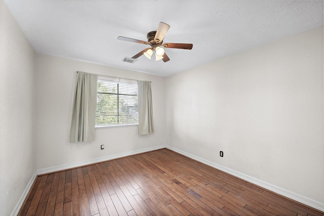 empty room featuring hardwood / wood-style flooring and ceiling fan