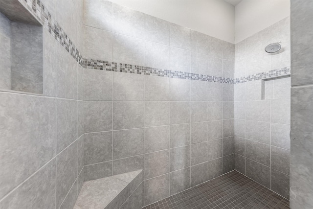 bathroom with tiled shower