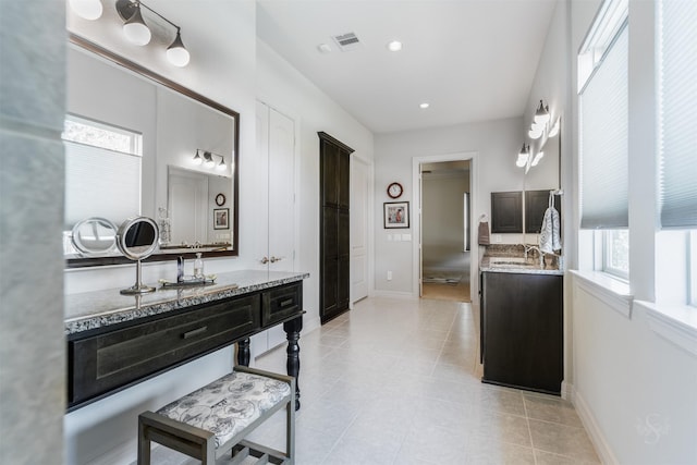 bathroom with tile patterned flooring, vanity, and plenty of natural light