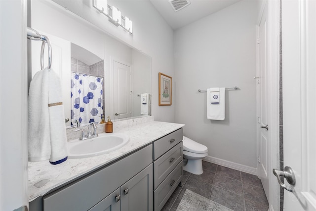 bathroom featuring vanity, toilet, and walk in shower