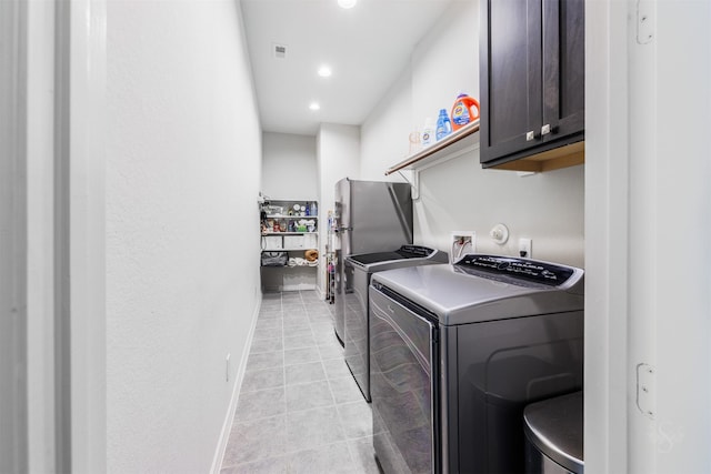 washroom with cabinets and independent washer and dryer