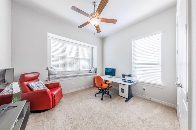 carpeted office featuring ceiling fan